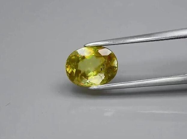 2.00ct 8.7x6.8mm Oval Natural Yellowish Green Sphene Madagascar, Amazing Luster