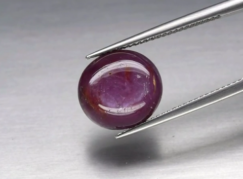 8.45ct 12.2x11.3mm Oval Cabochon Reddish Purple Sapphire Unheated Guinea